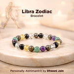 Libra Zodiac bracelet with multicolored beads on a marble surface, featuring the brand 'Dhwani Jain'.