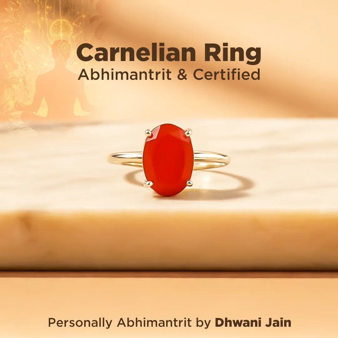 Carnelian ring with red stone on a wooden surface, labeled 'Carnelian Ring Abhimantrit & Certified' by Dhwani Jain.