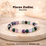 Pisces Zodiac bracelet with colored beads on a wooden surface, featuring the brand 'Dhwani Jain'.