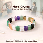 Multi crystal bracelet with colored beads on a white surface, with people in the background.