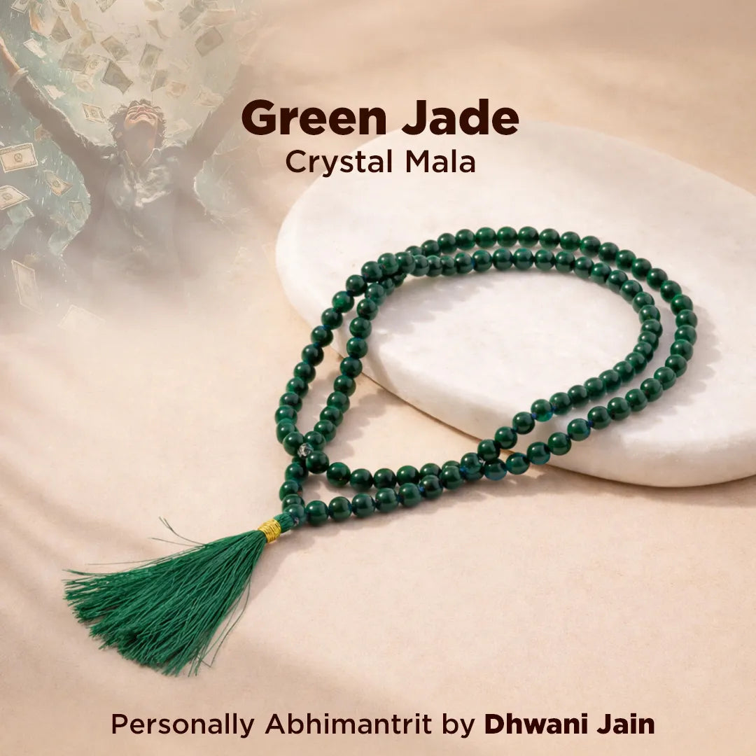 Green jade crystal mala necklace on a white stone surface with text indicating brand and personal abhimantrit by Dhwani Jain.