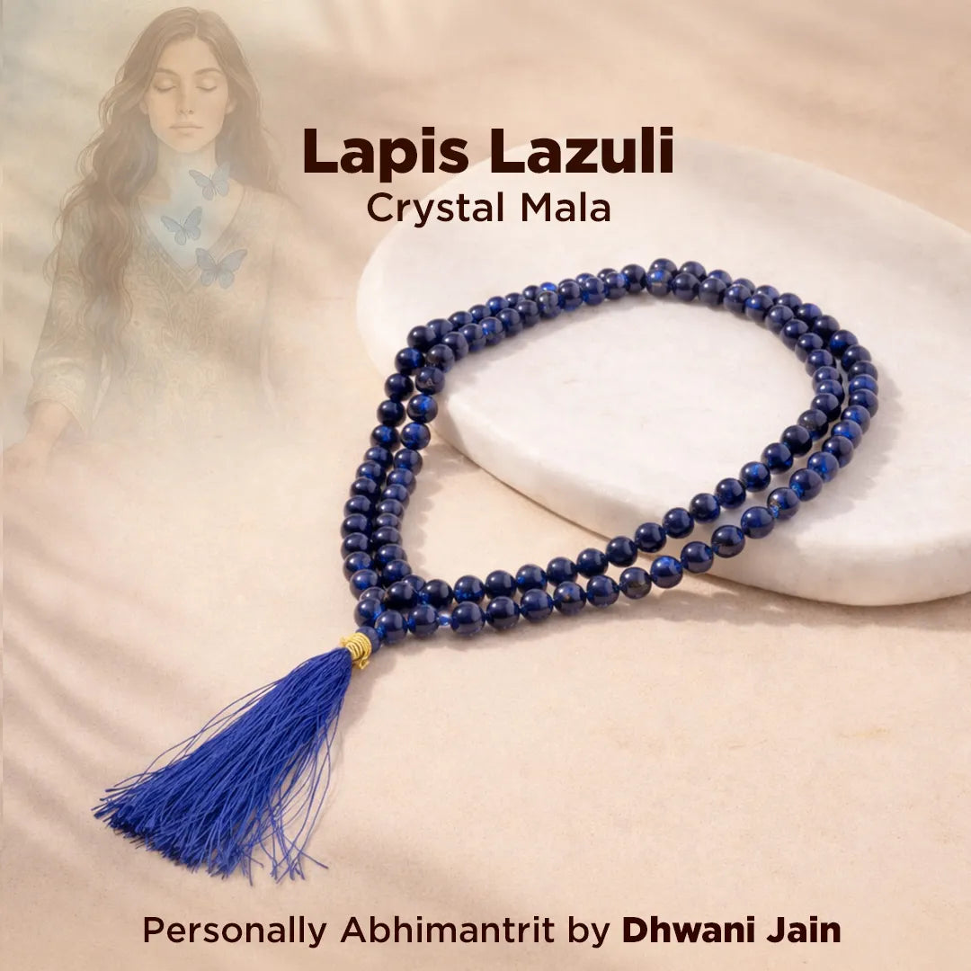 Lapis Lazuli crystal mala necklace with tassel on a white surface, featuring the brand 'Dhwani Jain'.