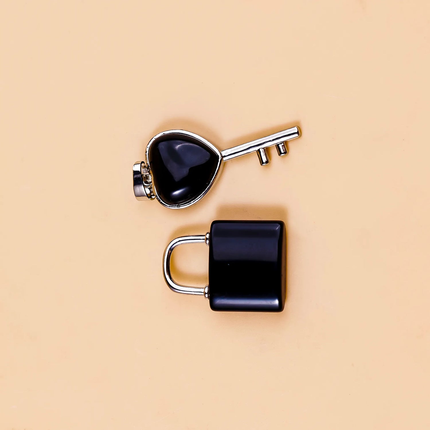 Black padlock and key on a beige background