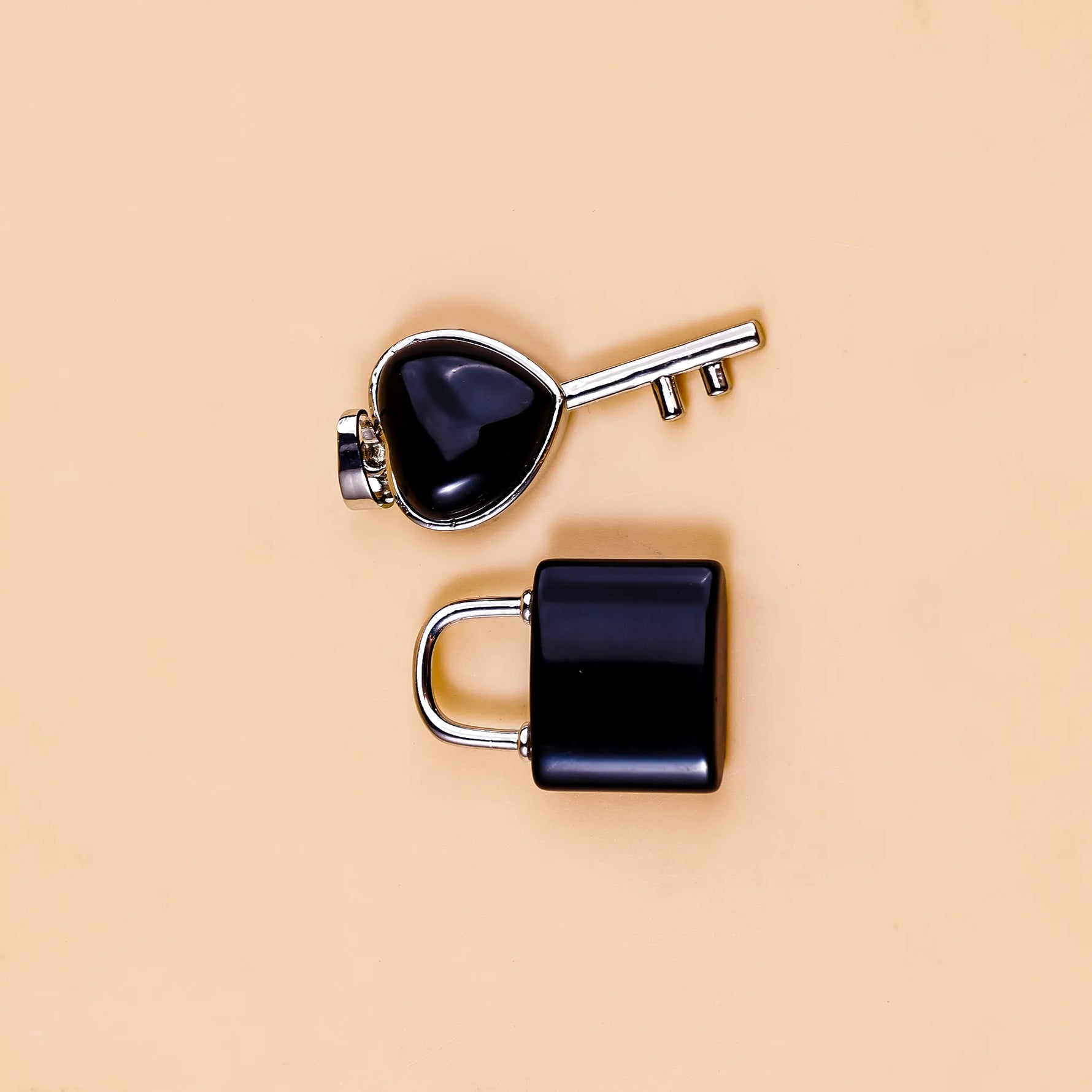 Black padlock and key on a beige background