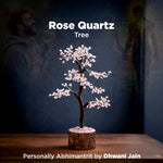 Rose Quartz Tree on a wooden surface with a dark background