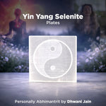 Yin Yang Selenite plates with two people in a field in the background