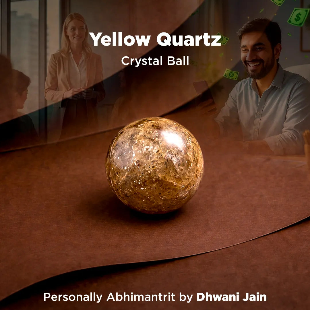 Yellow Quartz crystal ball on a reflective surface with people in the background