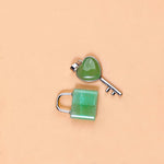 Green jade lock and key on a beige background