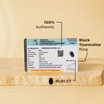 Black tourmaline ring with certification label on a beige background