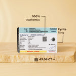 Pyrite ring with gemstone identification report on a beige background