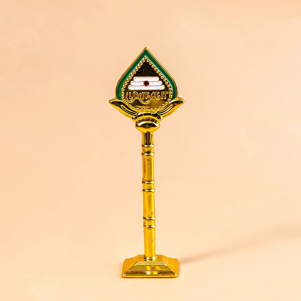 Decorative object with a green and gold design on a beige background