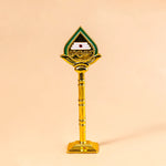 Decorative object with a green and gold design on a beige background