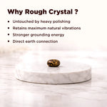Rough crystal on a marble platform with text explaining benefits of using rough crystals.