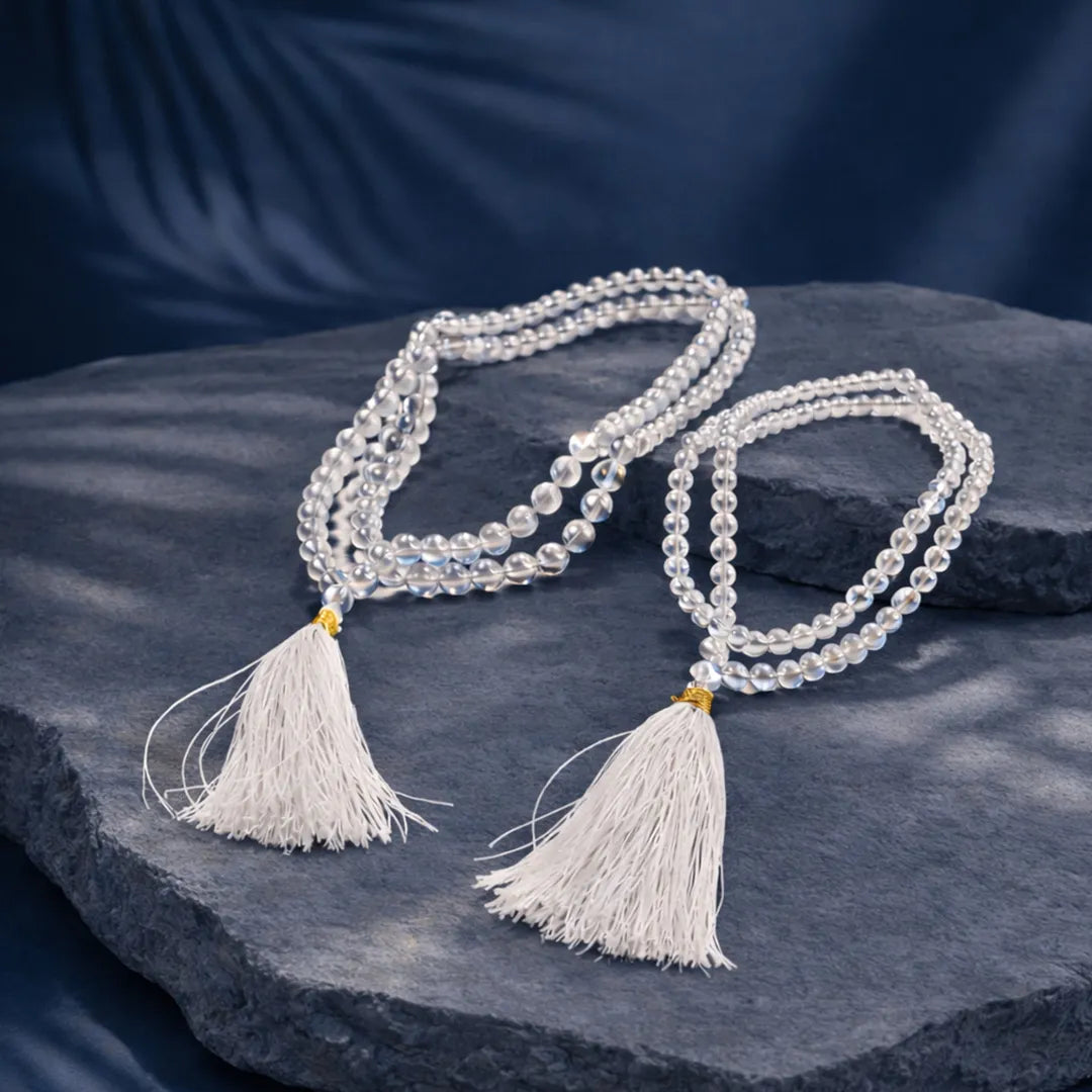 Crystal beaded necklace with tassels on a dark stone surface