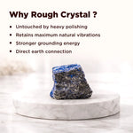 Rough crystal on a marble stand with text explaining benefits of using rough crystals.