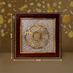 Decorative wall art with gold circular design and wooden frame, shown with measurements on a brown background.