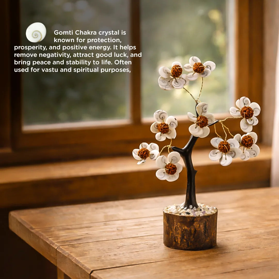 Decorative crystal tree on a wooden surface with text about Gomti Chakra crystal.बुरे प्रभावों से बचाता है और सकारात्मक ऊर्जा लाता है वृक्ष (गोमती चक्र और रुद्राक्ष वृक्ष)-अभिमंत्रित