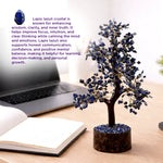 Lapis lazuli crystal tree on a desk with laptop and notebook