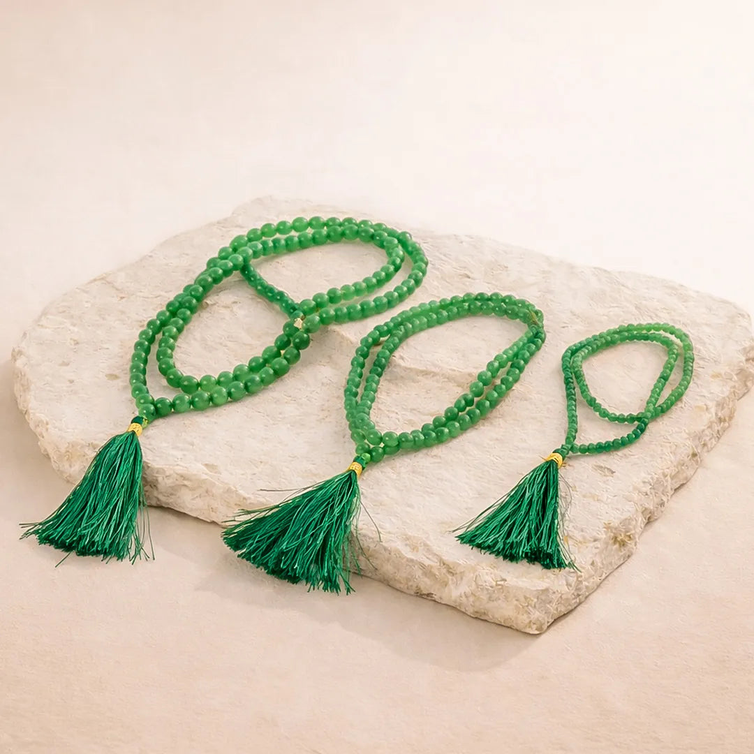 Green beaded necklace with tassels on a stone surfaceGreen Aventurine Crystal Mala – Luck, Opportunity & Financial Growth