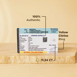 Yellow citrine ring with gemstone certification on a beige background