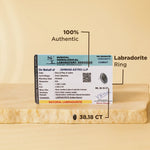 Labradorite ring with certification on a beige background