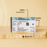 Pyrite ring with certification label on a beige background