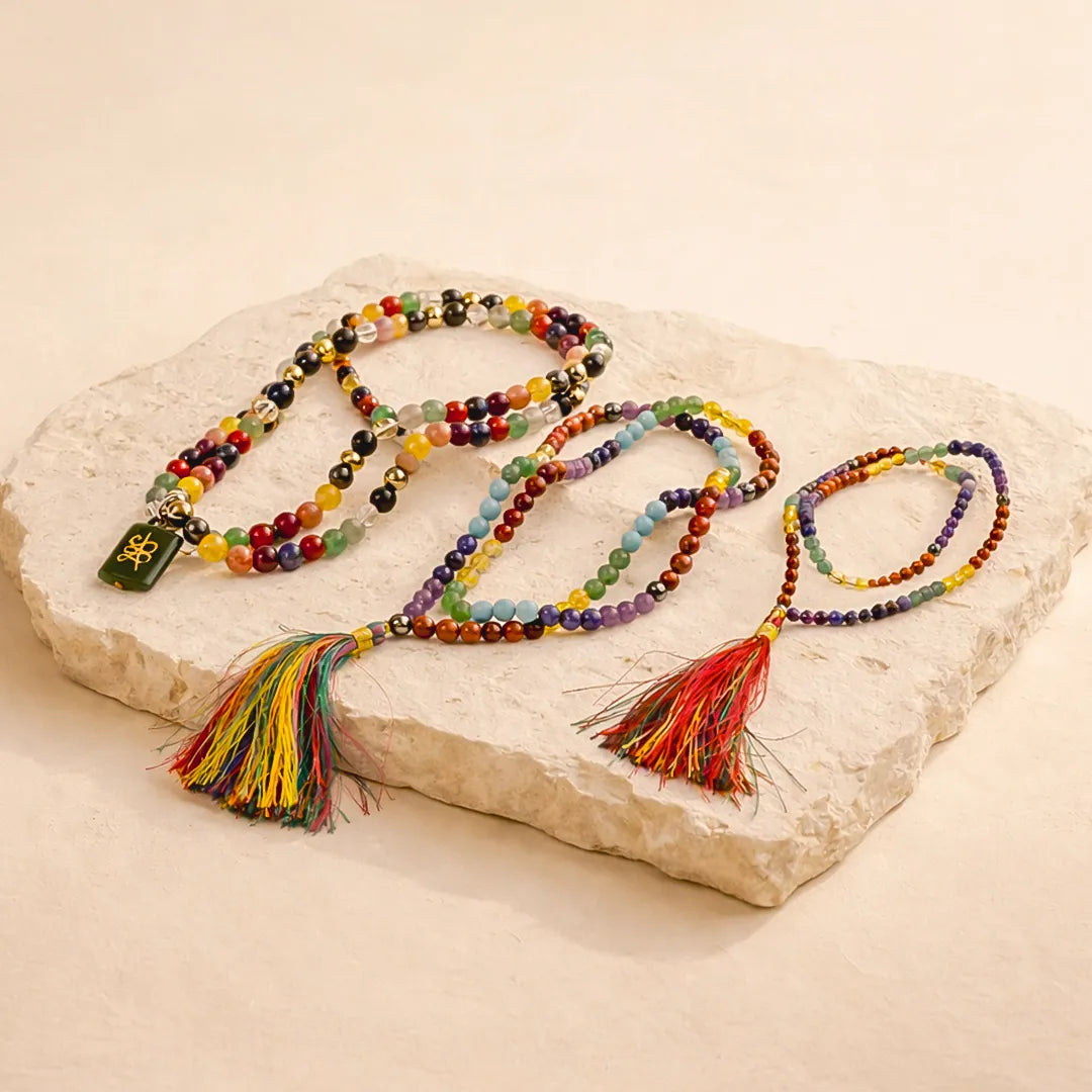 Colorful beaded necklaces with tassels on a stone surfaceसात चक्र जप माला-अभिमंत्रित एवं प्रमाणित