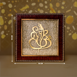 Decorative wall art with gold design and wooden frame on a brown background