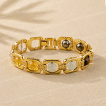 Gold bracelet on a beige fabric background