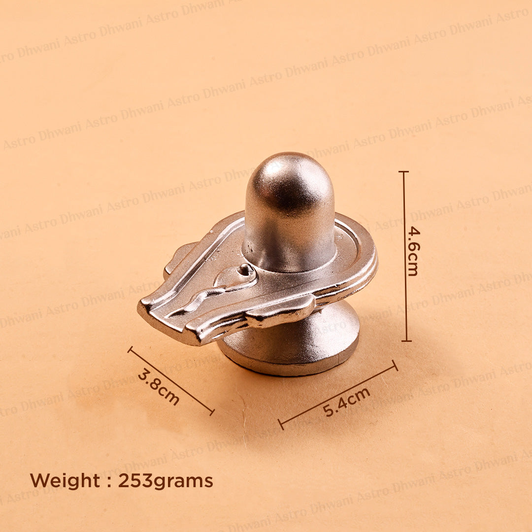 A metallic silver Shiva Lingam shown on a beige backgroundParadeshwar Shivling | Shiva Lingam for Puja & Abhishek | Sacred Idol