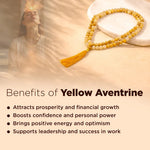 Yellow aventurine beads with a person meditating in a warm-toned setting