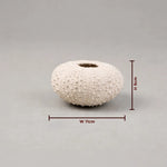 White textured vase with dimensions on a gray background