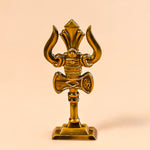 Decorative gold emblem with a central design on a beige background