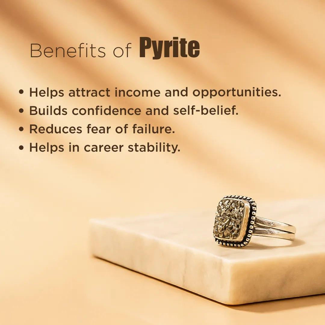 Pyrite ring on a marble surface with text about its benefits on a beige background