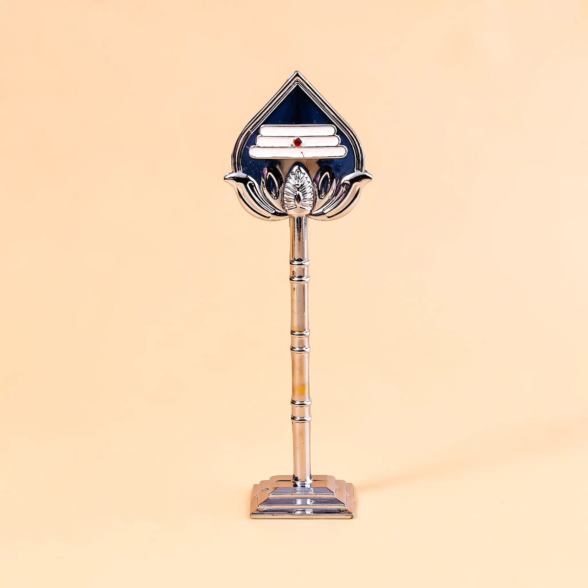 Decorative object with a central emblem on a beige background
