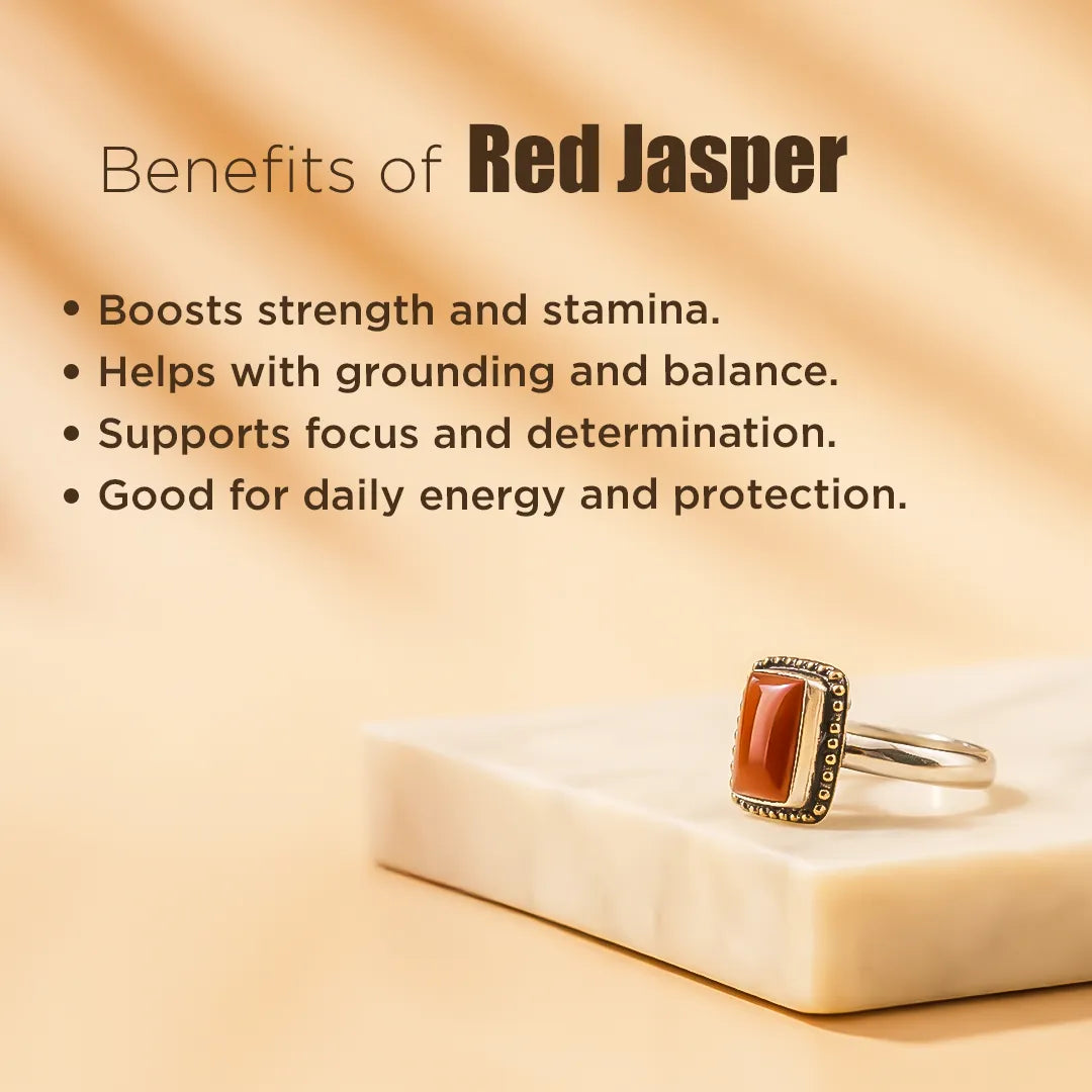 Red jasper ring on a beige surface with text listing benefits of red jasper.Red Jasper Ring: Courage and Confidence