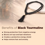 Black tourmaline necklace with tassel on a stone surface, benefits listed below.
