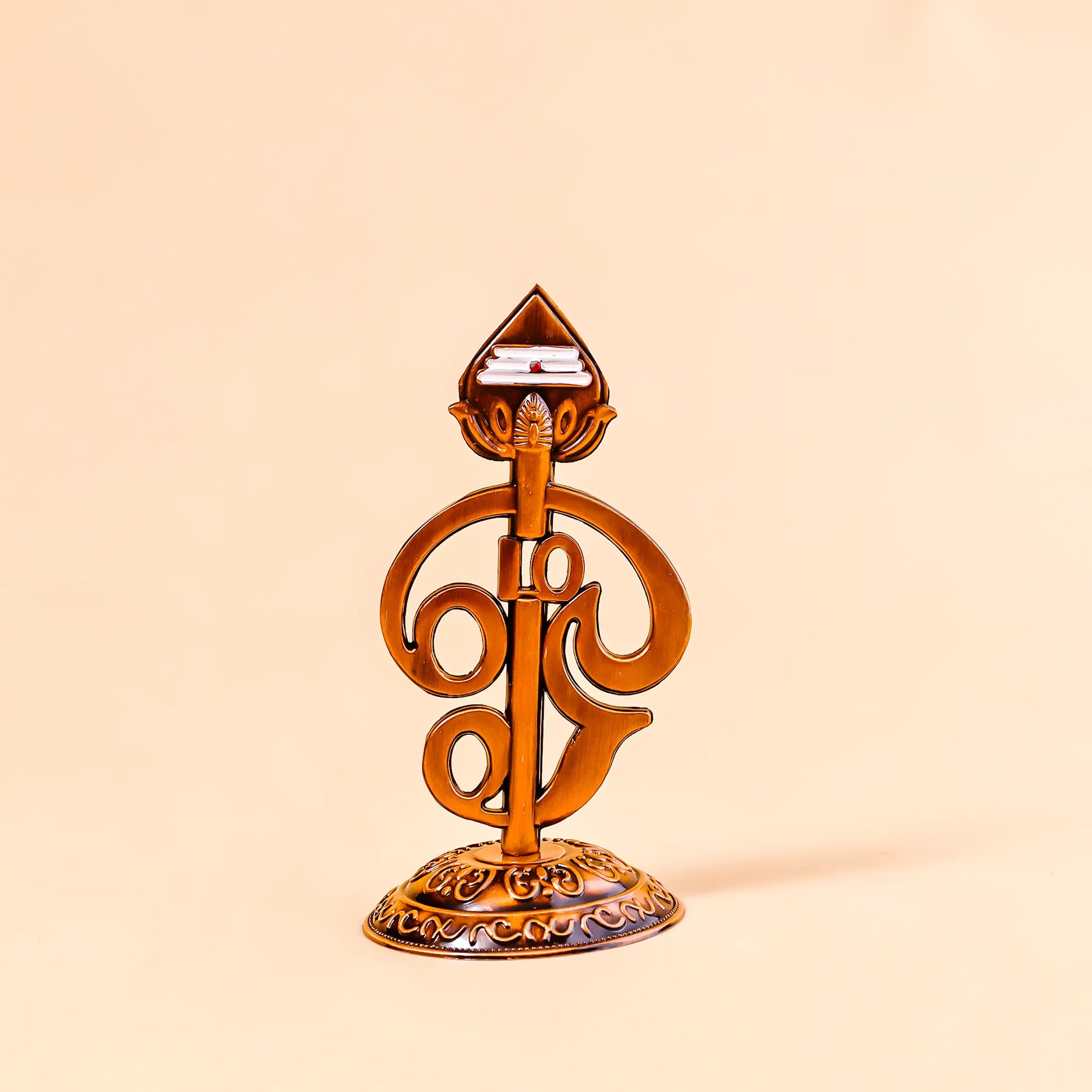 Decorative object with intricate design on a beige backgroundOm Vel – Divine Protection Symbol | Abhimantrit & Certified