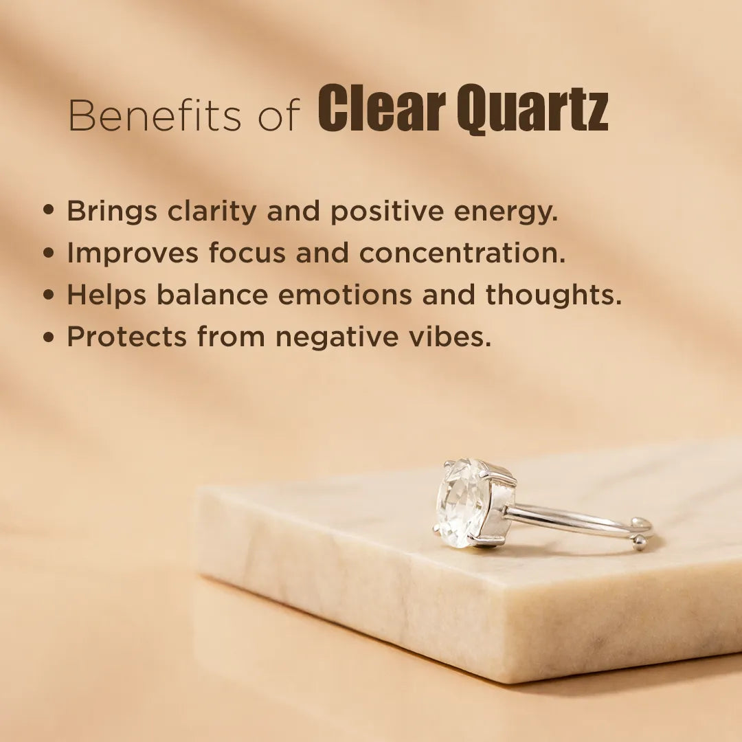 Clear quartz ring on a marble slab with text about its benefits on a beige backgroundClear Quartz Ring: Removes Depression, Anger & Anxiety