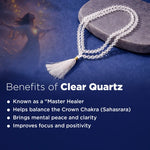 Clear quartz necklace with tassel on a blue background, featuring text about its benefits.