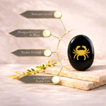 Black crystal with gold crab design on a beige background with text about its features.