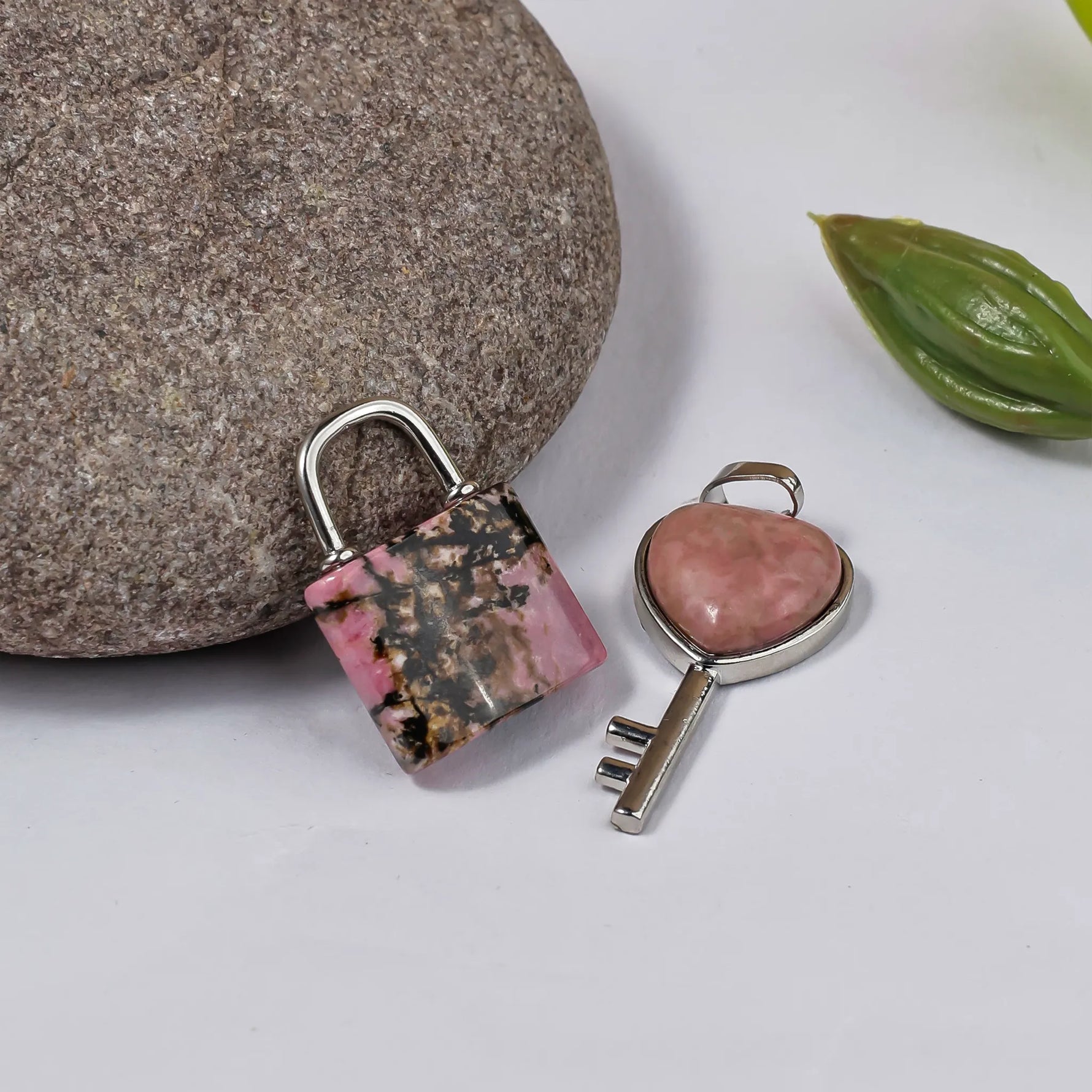 Lock and key with pink stone accents on a white background