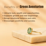 Gold ring with green gemstone on a beige background with text about green aventurine benefits.
