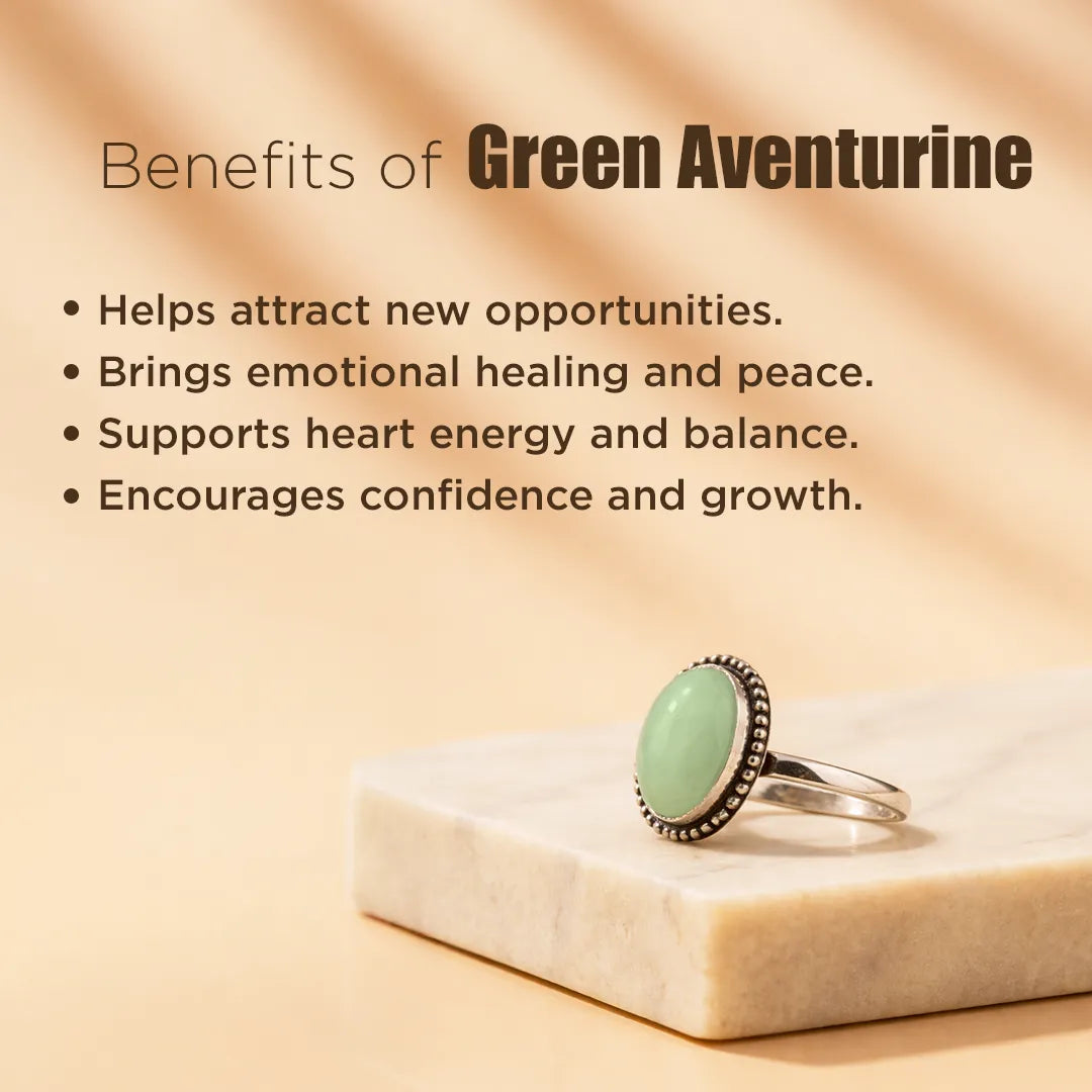 Green aventurine ring on a beige surface with text about its benefits.