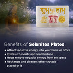 Selenite plate with symbols on a table with a blurred person in the background