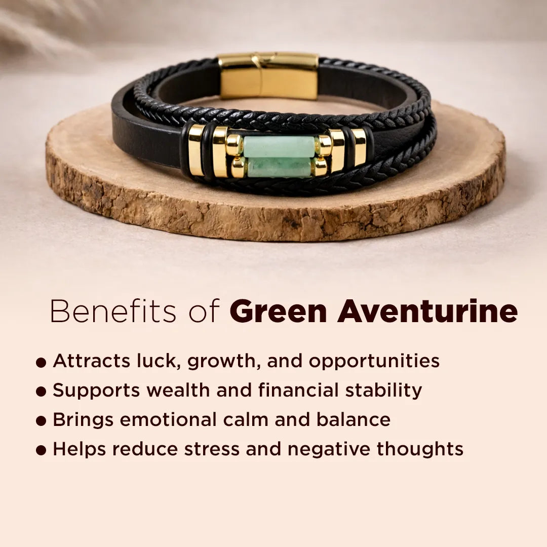 Black leather bracelet with gold accents and a green stone on a wooden surface, with text about green aventurine benefits.