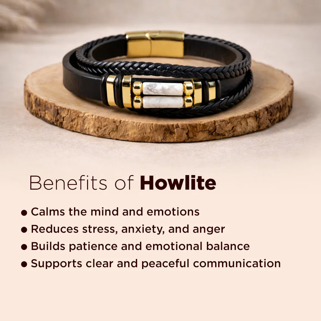 Black leather bracelet with gold accents on a wooden surface, benefits of howlite text below.Howlite Leather Bracelet – Calm Mind, Patience & Stress Control Wear