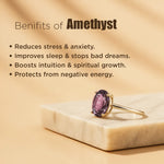 Amethyst ring on a marble base with text about amethyst benefits on a beige background