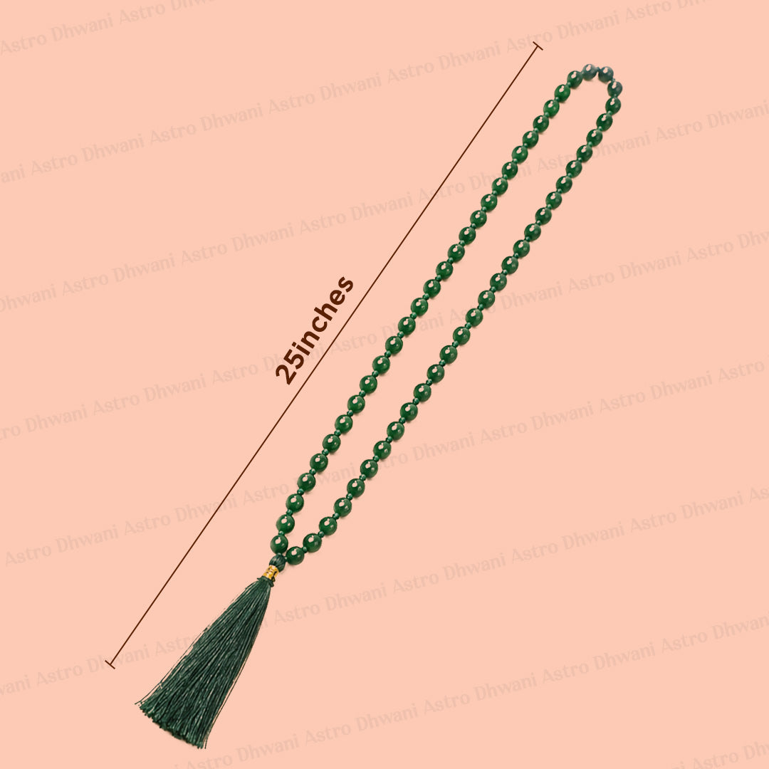 A green aventurine beaded necklace with a tassel and a gold spacer, shown on a peach background with a dimension line indicating a length of 25 inches.एमिथेस्ट जाप माला- अभिमंत्रित और प्रमाणित