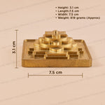 A brass saraswati yantra shown on a beige background with overlaid dimension lines and text listing height, length, width, and weight.